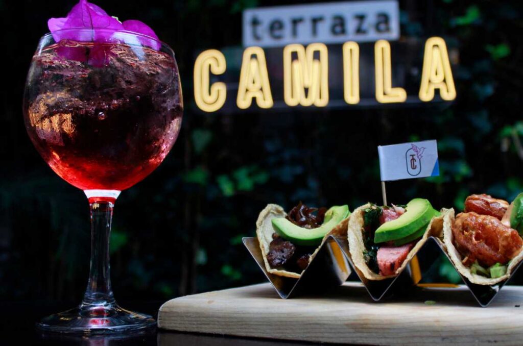 Foto de unos tacos, con un trago en Terraza Camila