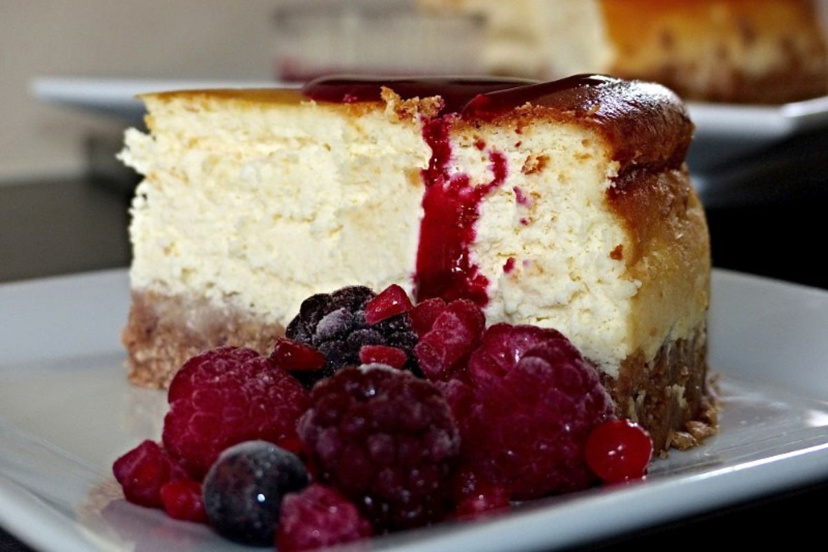 Rebanada de cheesecake con compota de frutos rojos. Foto de Flickr.