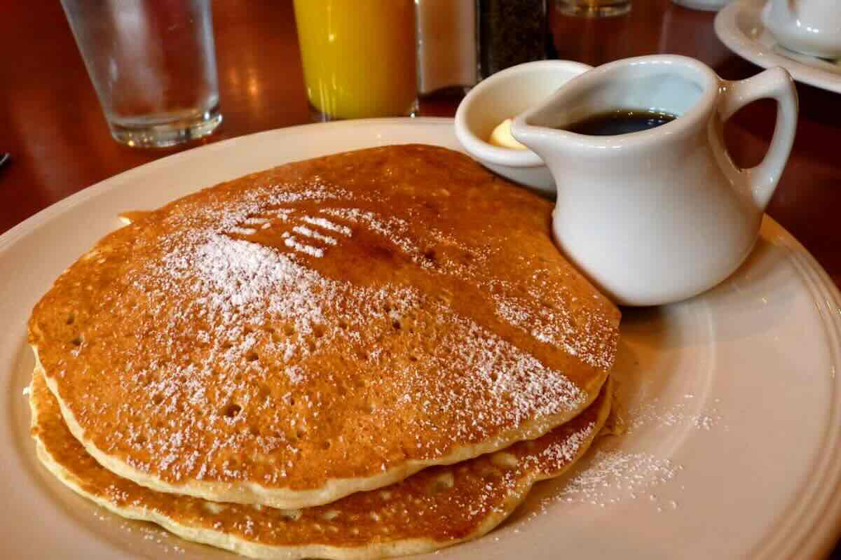 Pancakes recién hechos, acompañados de miel de maple. Foto de Flickr.